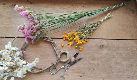 bottes de fleurs séchées sur une table d'atelier